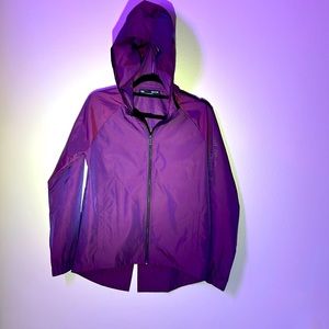 NWOT. Unique under armor rain shell women’s coat. Size S, in a purple metallic.